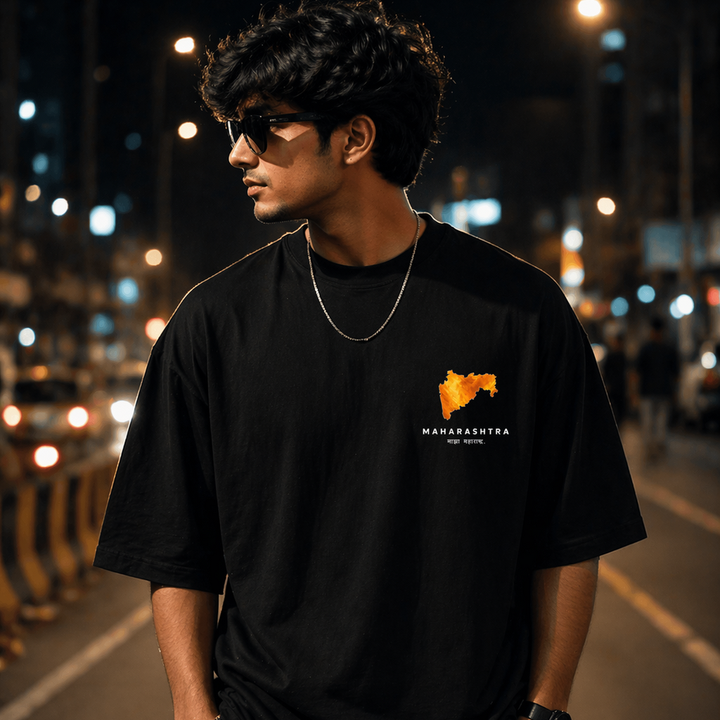 Person wearing a black t-shirt with a logo on a street at night