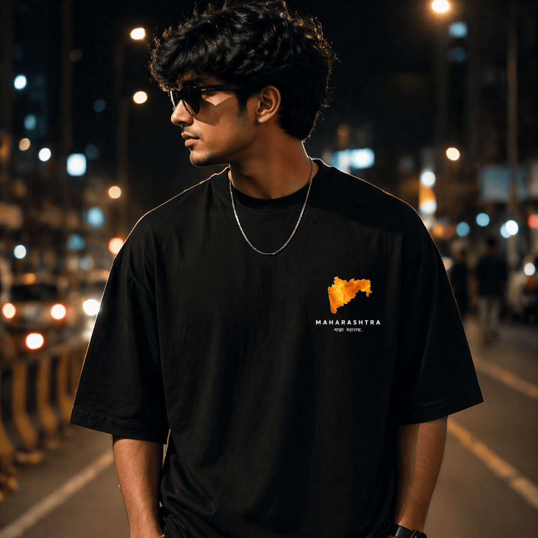 Person wearing a black t-shirt with a logo on a street at night