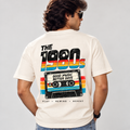 Back of off-white retro T-shirt worn by a man, with THE 1980s rainbow lettering and Good Music Better Days cassette graphic.