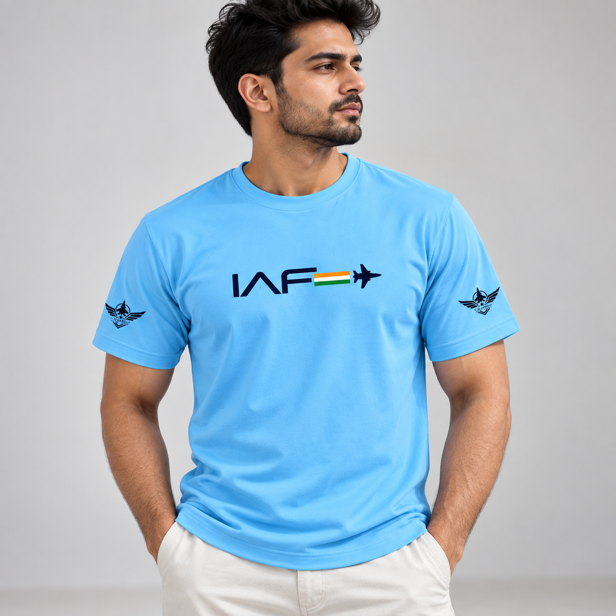 Model wearing sky-blue IAF graphic T-shirt with jet and tricolor chest print and black winged sleeve emblems.