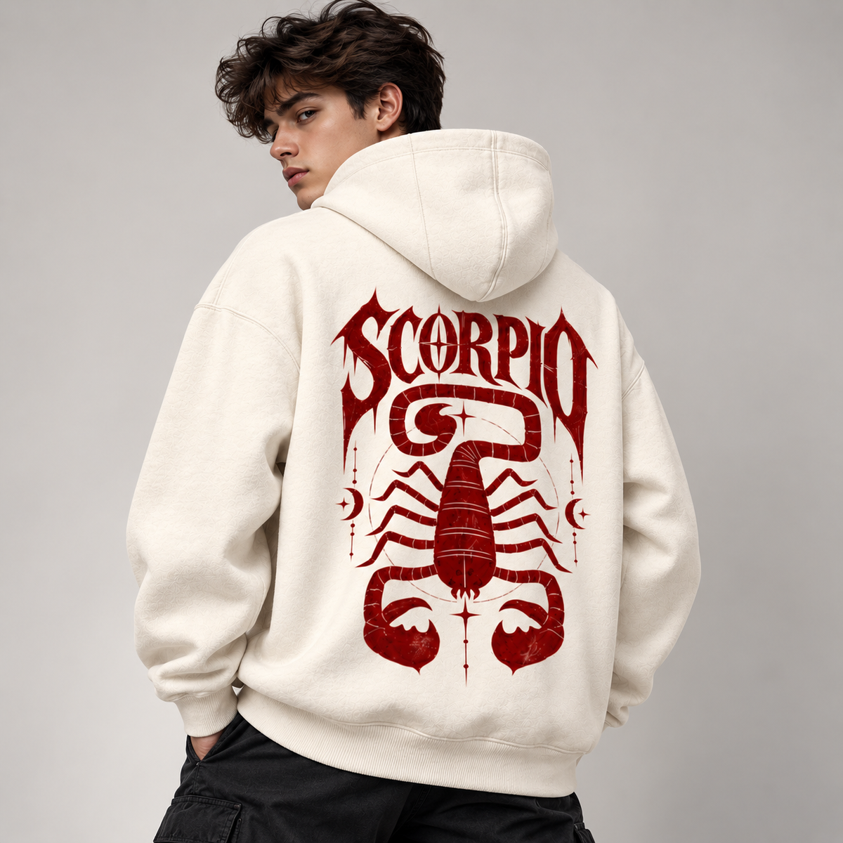 Model showing back of off-white Scorpio hoodie with burgundy gothic SCORPIO lettering and oversized scorpion graphic.