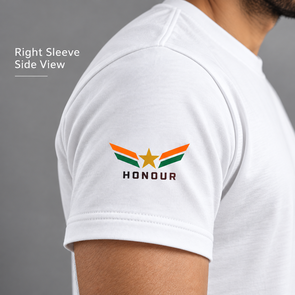 Right sleeve detail of white India Pride T-shirt with orange-and-green wing emblem, gold star and HONOUR print.