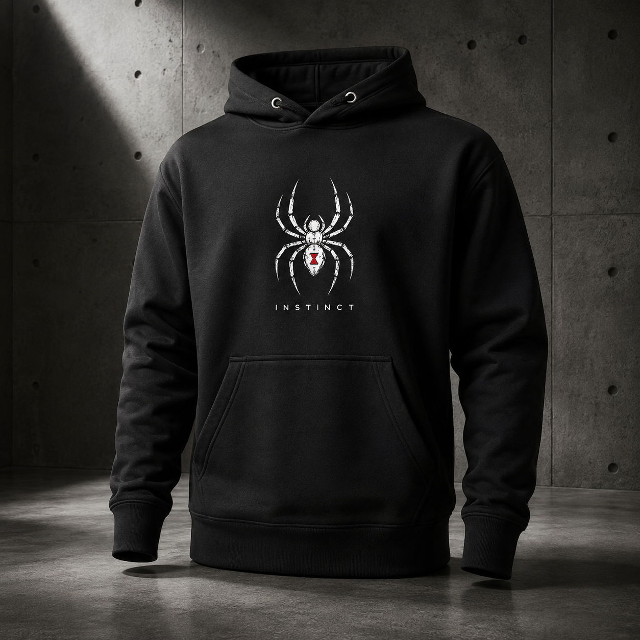 A black pullover hoodie with a white spider graphic and the word 'INSTINCT' on the chest, displayed against a dark concrete wall background.