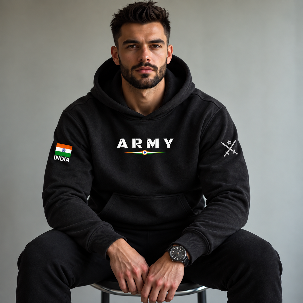 Model wearing a black Army pullover hoodie with tricolor chest print, Indian flag sleeve patch and crossed-swords detail.