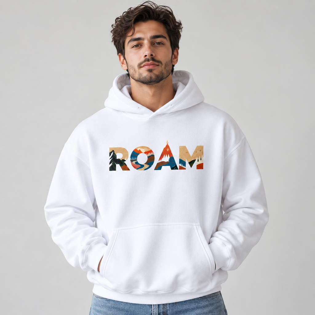 Man wearing white ROAM pullover hoodie with colorful outdoor scenes in the chest lettering, a front pouch pocket and blue jeans.