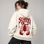 Woman modeling the back of an off-white Scorpio hoodie with bold burgundy SCORPIO lettering and scorpion illustration.